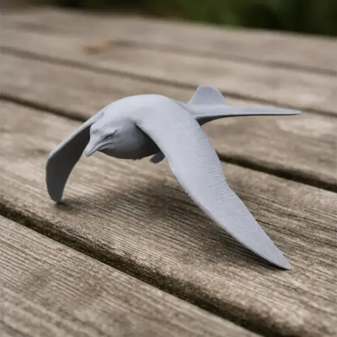 A 3D-printed, smooth-textured Arctic Skua model with outstretched wings on a wooden surface.