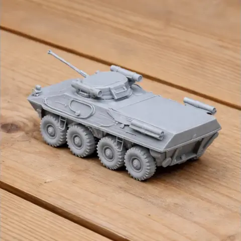 A detailed 3D-printed model of a BTR-90 armored vehicle on a wooden surface.