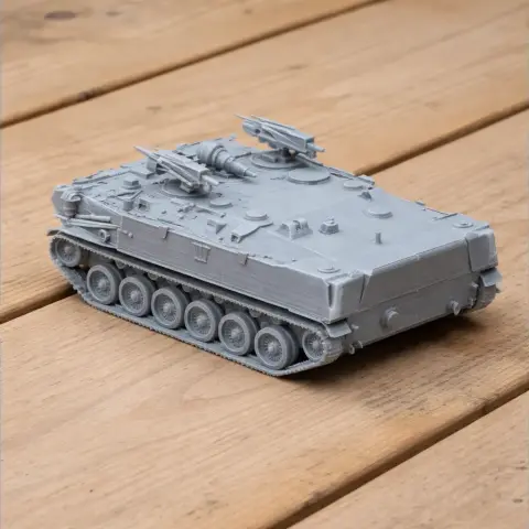 Gray 3D-printed BTR-D tank model on a wooden surface, detailed with tracks and turret.