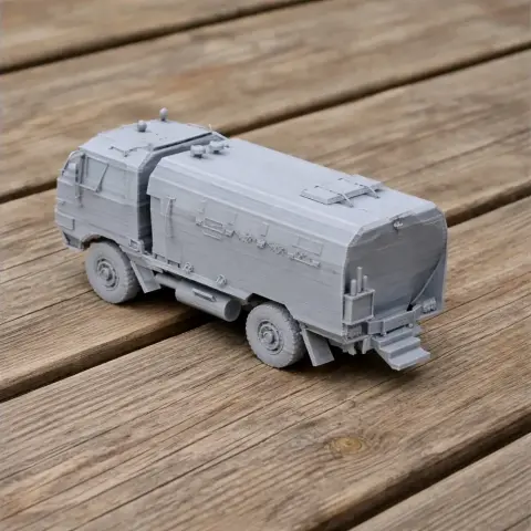 3D-printed model of a Burraq MRAP vehicle, displayed on a wooden surface.