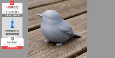 A 3D printed model of a round, plump bird with detailed wings and feet, placed on a wooden surface.