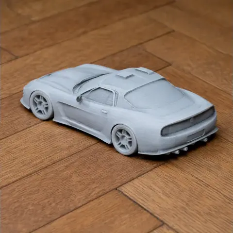 3D printed model of a Callaway C12 car on a wooden surface.
