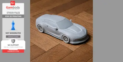 3D-printed scale model of a sleek car on a wooden surface.