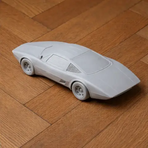 3D printed model of a Chevrolet Aerovette car on a wooden floor.