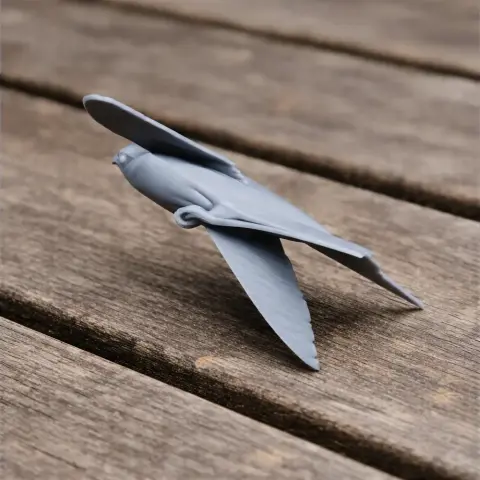 Gray 3D model of a prehistoric bird with wings outstretched, displayed on a wooden surface.