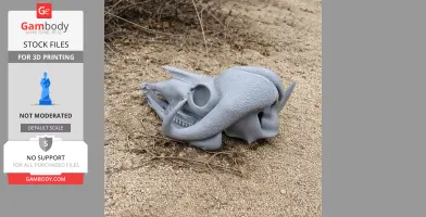 3D-printed musk ox skull replica on sandy ground.