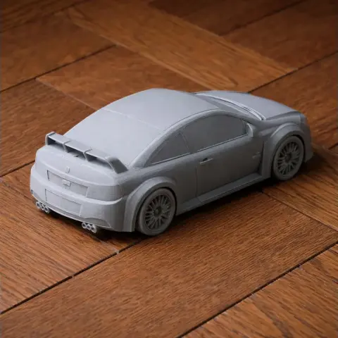 3D-printed gray Chevrolet Cobalt SS model on a wooden surface.