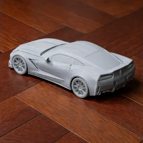 3D-printed model of a Chevrolet Corvette C7 on a wooden floor.