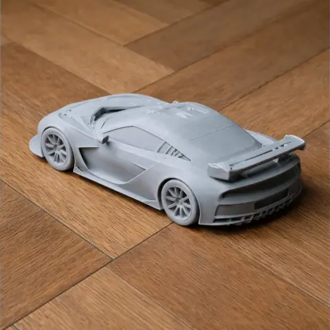 3D printed model of a Chevrolet Corvette C6.R on a wooden surface.