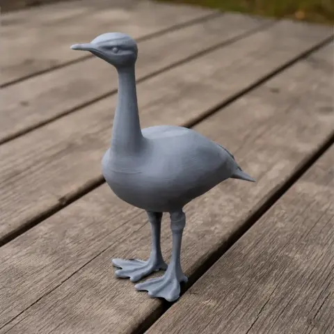 3D printed model of a bird with long neck and legs, standing on a wooden surface.