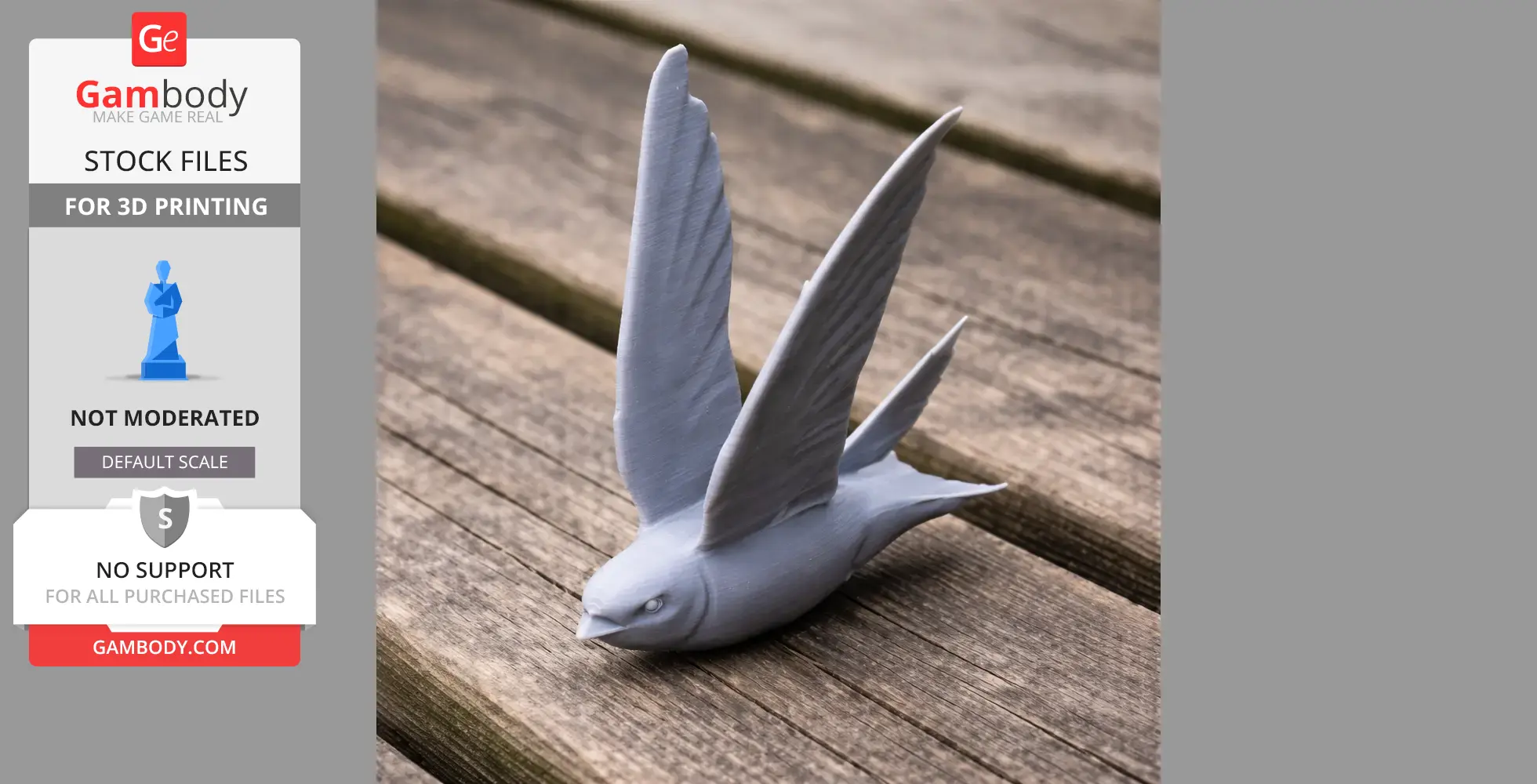 A gray 3D printed model of a bird with open wings, resting on a wooden surface.