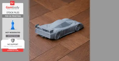 Gray 3D-printed model of a Chevrolet Corvette GTP on a wooden surface.