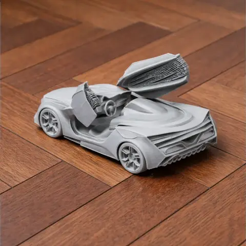 3D printed model of a Chevrolet Miray car with open scissor doors on wooden floor.
