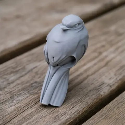 A 3D-printed model of a prehistoric bird, perched on a wooden surface.