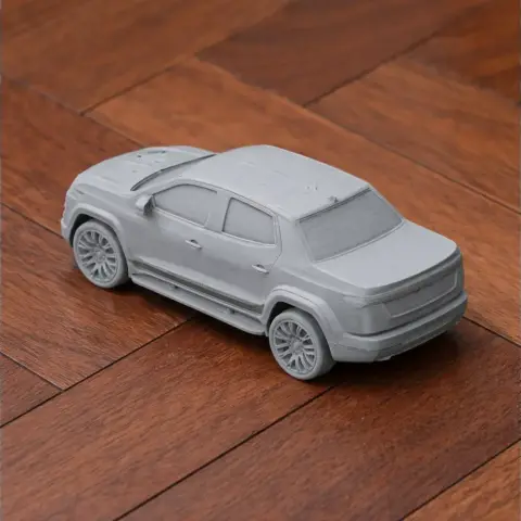 3D printed model of a Chevrolet Silverado EV on wooden surface.