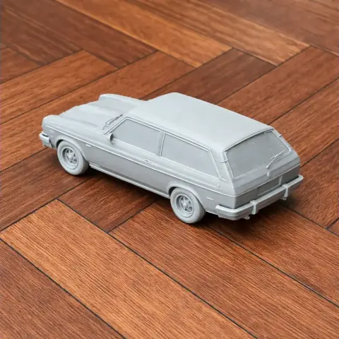A 3D-printed model of a Chevrolet Vega on a wooden floor.