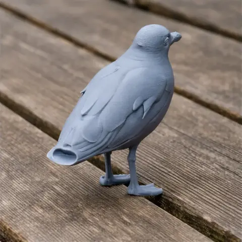 Gray 3D-printed model of a bird standing on a wooden surface.