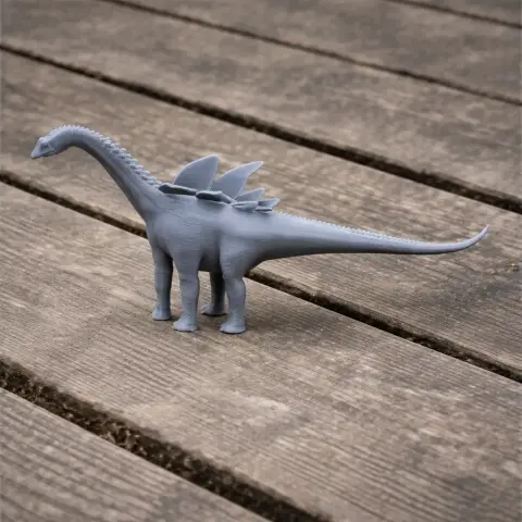3D-printed model of Agustinia, a long-necked dinosaur with dorsal plates, on a wooden surface.