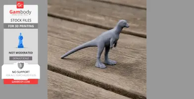 A small, gray 3D-printed dinosaur model stands on a wooden surface.