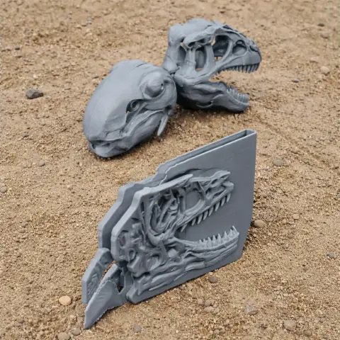 3D printed Ornatotholus dinosaur skull and engraved plaque on sandy ground.