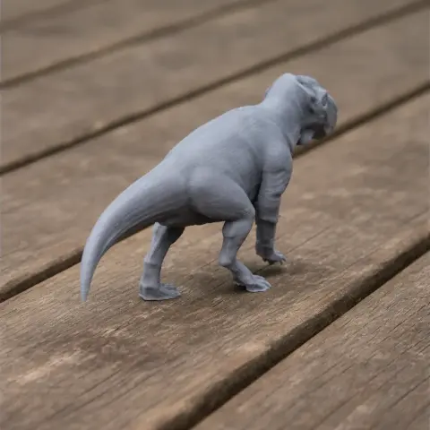 Gray 3D-printed dinosaur model, Ajkaceratops, on a wooden surface.