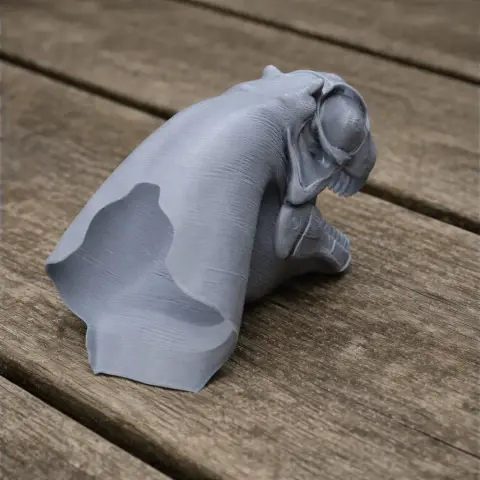 3D-printed Alashansaurus dinosaur model in gray, resting on a wooden surface.