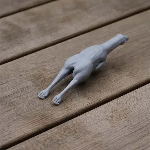 A 3D printed model of an Albertonykus dinosaur on a wooden surface.