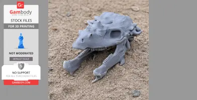 Gray 3D-printed Pachysaurus skull model resting on sandy ground.