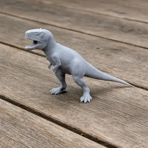 A 3D-printed dinosaur model with an open mouth, standing on wooden planks.