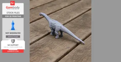 A gray 3D-printed model of an Ampelosaurus dinosaur on a wooden surface.