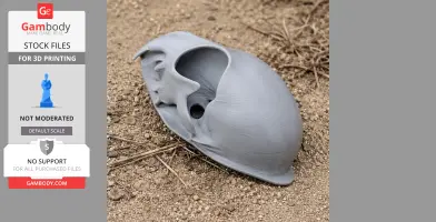 Gray 3D-printed Pallas's cat skull replica on rough ground.