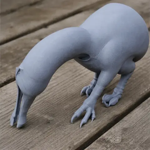 Gray 3D printed model of Angaturama, a prehistoric dinosaur, standing on a wooden surface.