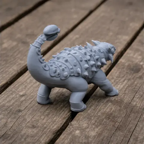 A 3D-printed ankylosaurus model with a spiked back and clubbed tail on a wooden surface.