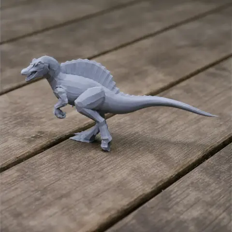 A 3D-printed model of a dinosaur with a sail-like back, positioned on a wooden surface.