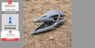 3D printed dinosaur skull model on sandy ground.