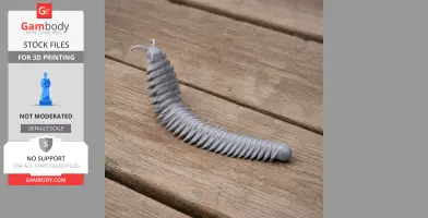 A gray 3D printed Arthropleura model with segmented body, displayed on a wooden surface.