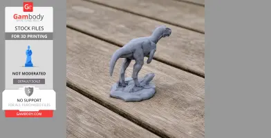 Gray 3D printed Asfaltovenator dinosaur model on a textured wooden surface.