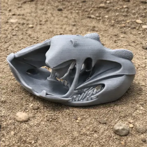3D printed Qinlingosaurus skull replica, displayed on a textured surface.