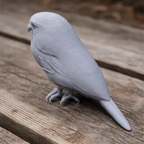 3D-printed model of an Austral pygmy owl perched on a wooden surface.