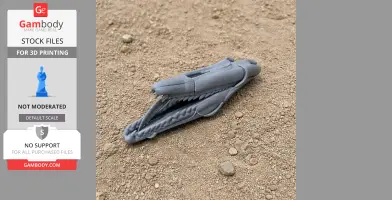 Gray 3D-printed Qunkasaura skull replica on sandy ground.