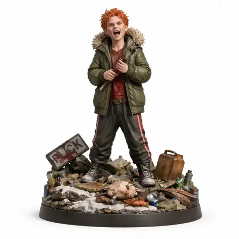 A young character figure with red hair in a green coat stands amidst trash and a sign on a detailed base.