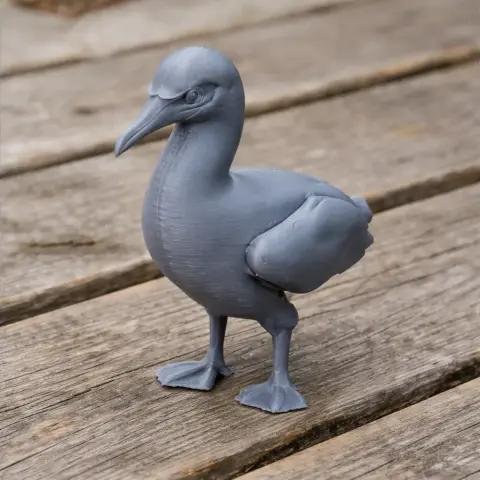 3D-printed model of a prehistoric gannet bird, standing on a wooden surface.