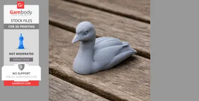 3D printed model of an Australasian grebe, gray, resting on wooden surface.