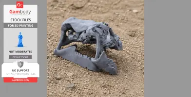 3D-printed Rhabdodon skull model in grey, displayed on a textured surface.