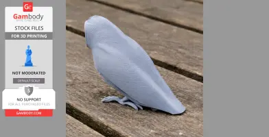 Gray 3D printed model of an Australian masked owl on a wooden surface.