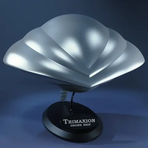 Futuristic silver spaceship model with sleek curves on a stand labeled 'Trimaxion Drone Ship'.