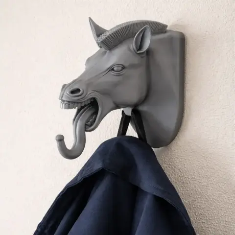 3D printed zebra head wall hook holding a coat, designed for keys and accessories.