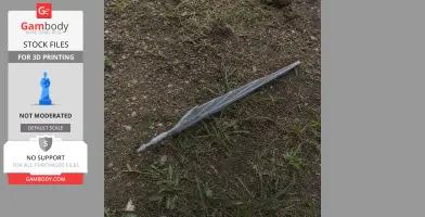 A gray, 3D-printed sword with a twisted design lies on gravel and grass.