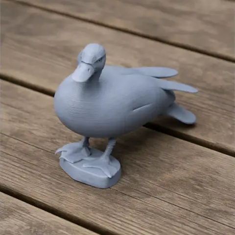 3D-printed model of an Australian shelduck, gray, standing on a wooden surface.
