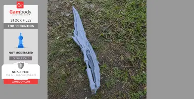 A detailed 3D-printed fantasy blade prop lying on grass.